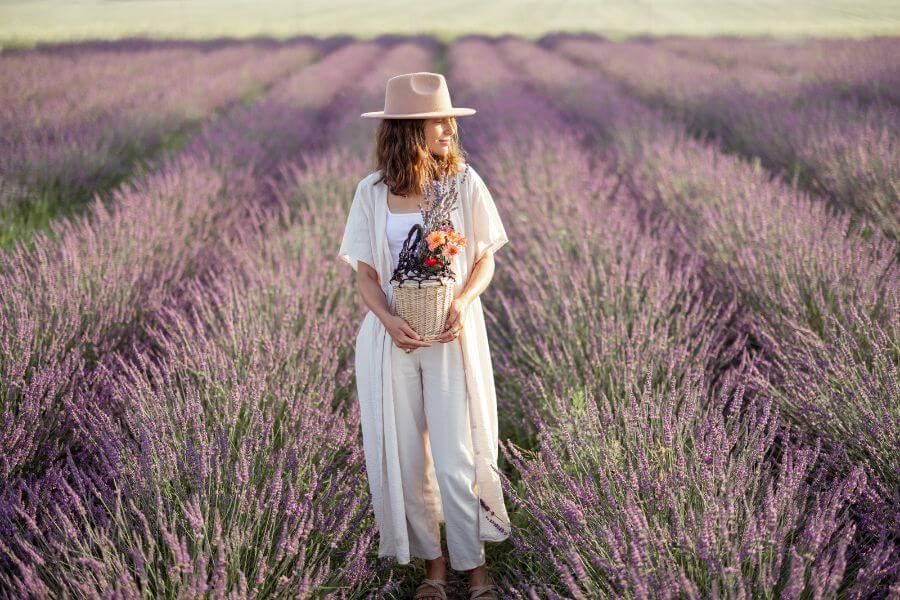 Woman standing silent in front of field of lavender..