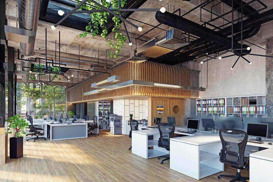 Biophilic Office with large windows looking out with plenty of natural sunlight and a pleasing arrangements with plants hanging overhead in an open spacious office setting.